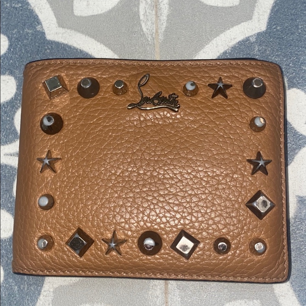 Previously loved authentic louboutin wallet!